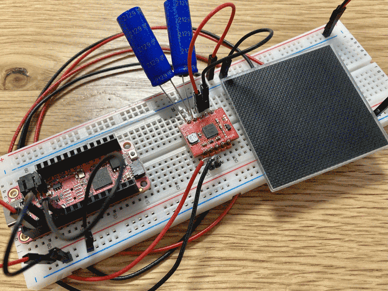 The current prototype: RP2040 Feather, Jasper Sikken’s AEMSUCA board, two supercapacitors, and a small 2v solar panel